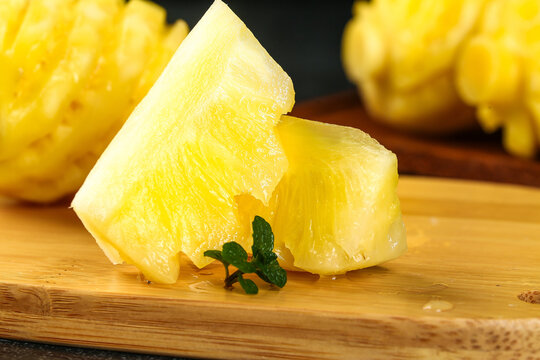Fresh Peeled Lemon Wedges on Wooden Board with Mint