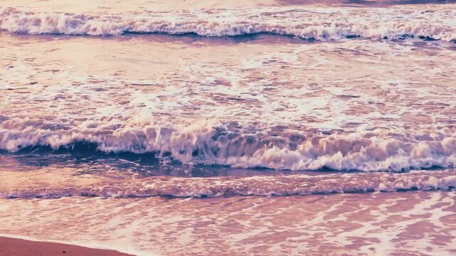 Surreal nostalgic ocean waves crashing on sand with blue purple and pink color grading