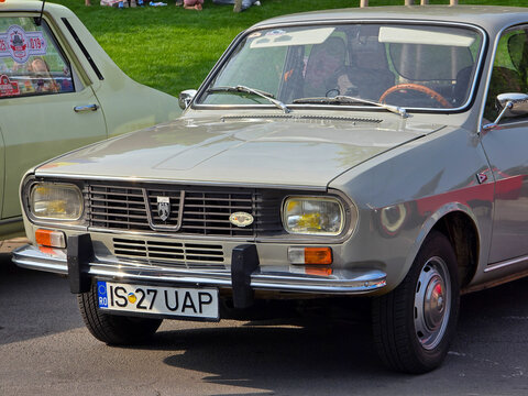 Piatra Neamt, Romania - June 7, 2025: Front view of a classic beige 1972 Dacia 1300 sedan, featuring its iconic design, chrome details, and Romanian license plate.