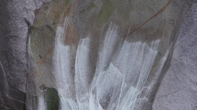 Water flows down steep rock waterfall - overhead view - Yakushima, Japan