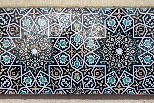 Geometric tilework detail on Bibi Khanum Mosque in Samarkand featuring star patterns and floral arabesques. Ideal for travel publications, cultural heritage projects, and design inspiration.