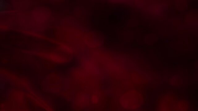 Red background with animated red light. Red velvet wave curve on dark background, smooth abstract flowing motion loop for titles