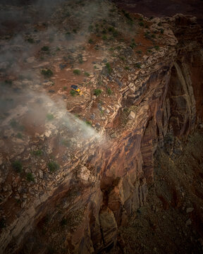 Yellow off road vehicle parked on a foggy cliff edge