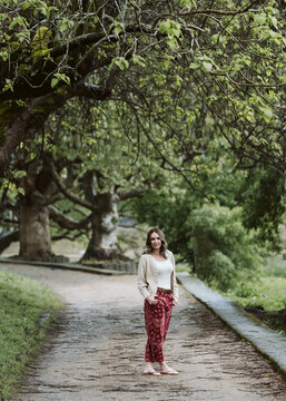 Stylish mature woman standing on a path in a park