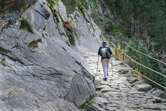 Man hiking John Muir trail on stone steps. Yosemite National Park. California. USA.