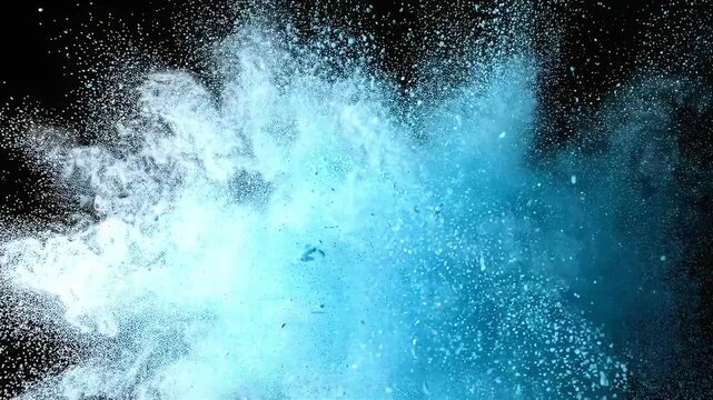 Vivid blue powder and particles explode and scatter violently against a black background.