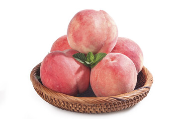 Fresh Ripe Peaches in Woven Basket with Mint Leaf © KieuBich