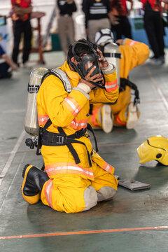 Firefighter Fitting Breathing Mask During Fire Safety Training Exercise