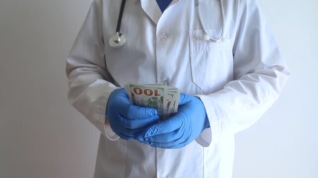 Close-up of doctor in white coat and blue gloves receiving or hiding cash. Concept of high medical salary, corruption in medicine, healthcare bribery, and expensive health insurance.