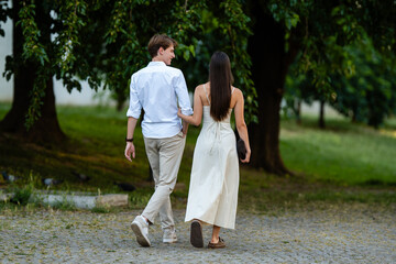 Fototapeta premium Couple walking arm in arm in park