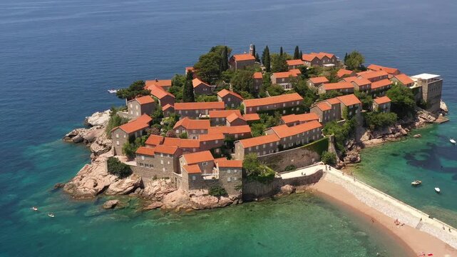 Aerial scenic view of Sveti Stefan island resort surrounded by turquoise Adriatic sea water in Montenegro.