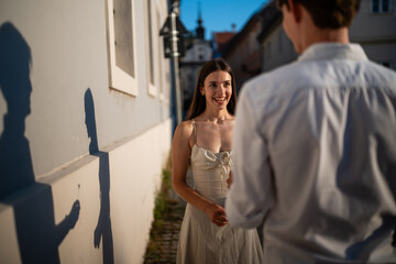 Fototapeta premium Romantic proposal shadow with young couple holding flower