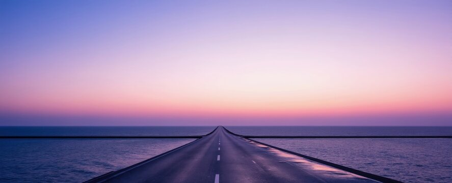 Long empty road leads toward horizon over sea at sunrise. Violet and pink sky gradient with calm ocean surface. Path forward to future hope and new beginnings.