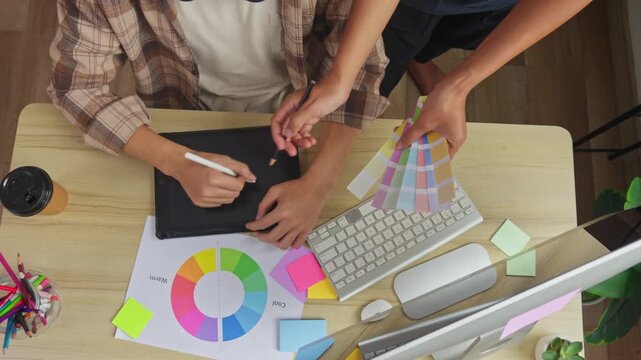 Close up of creative designer showing disagree hand gesture during color selection process