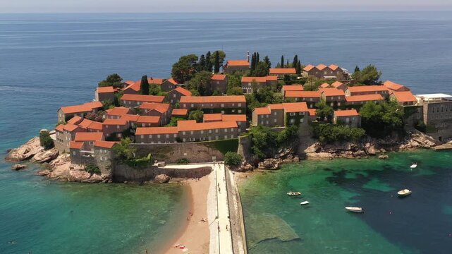 Aerial scenic view of Sveti Stefan island resort surrounded by turquoise Adriatic sea water in Montenegro.