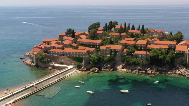 Aerial scenic view of Sveti Stefan island resort surrounded by turquoise Adriatic sea water in Montenegro.