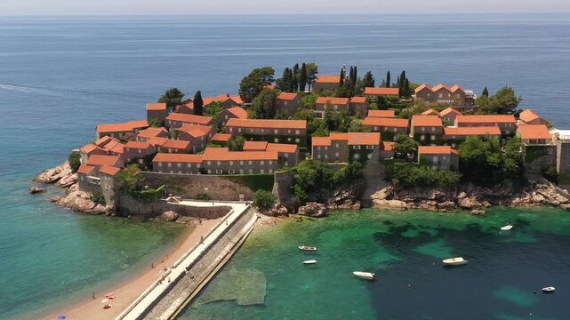 Aerial scenic view of Sveti Stefan island resort surrounded by turquoise Adriatic sea water in Montenegro.