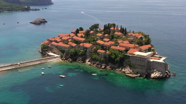 Aerial scenic view of Sveti Stefan island resort surrounded by turquoise Adriatic sea water in Montenegro.