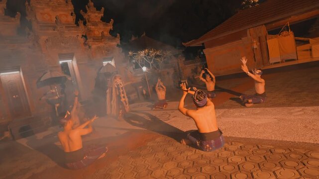 Back View of Men Worshipping Rangda Figure