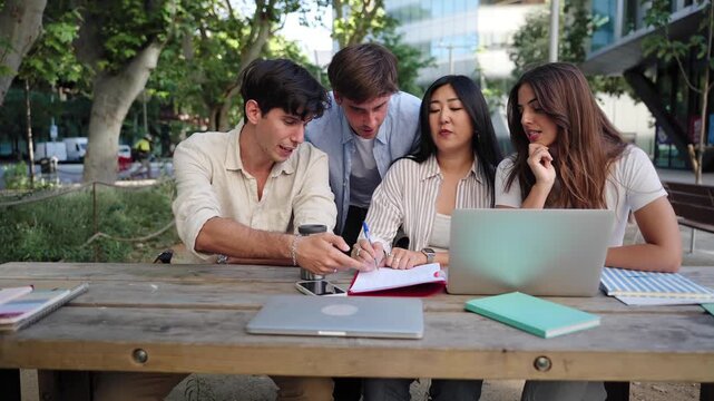 Group of students working and learning together using laptop to study for university exams