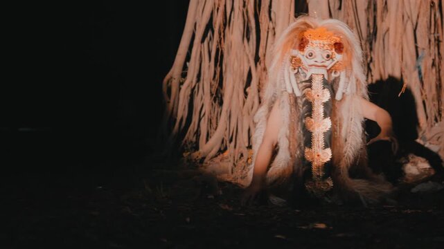 Creepy Rangda Demon Crawling Under Banyan Tree