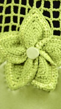 Zoom in refocus to knitted flower on dress close up