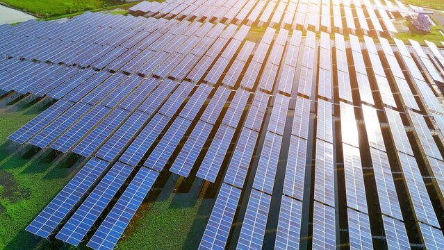 Wide aerial capture of solar panels under sunlight, highlighting clean energy, sustainable development, tech innovation, high efficiency, climate responsibility, green systems, and renewable growth.
