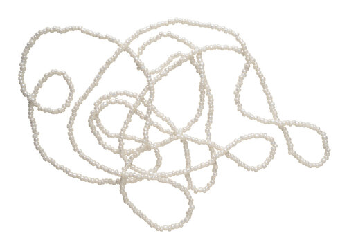 White seed beads tangled isolated on background. Tiny real pearl necklace elements. Fashion craft material. Object photo for jewelry catalogs, fashion branding, DIY craft blogs, scene creator