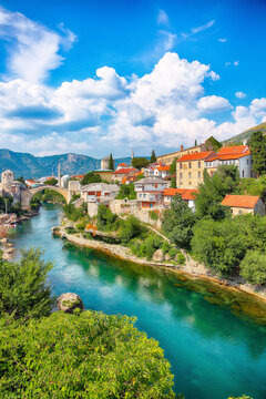 Amazing Skyline of Mostar with the Mostar Bridge, houses and minarets, during sunny day