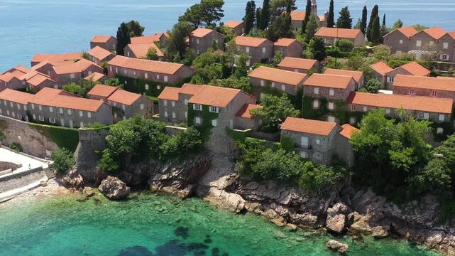 Aerial scenic view of Sveti Stefan island resort surrounded by turquoise Adriatic sea water in Montenegro.
