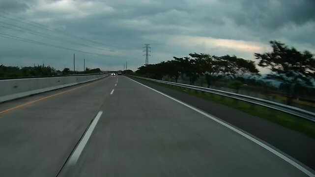 Rear Dashcam View of Highway Traffic with Mountain Landscape and Dramatic Clouds in 4K