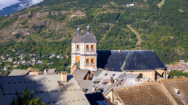 Saint-Nicolas Church towers over Briancon old town rooftops, Hautes-Alpes, France, Europe.
