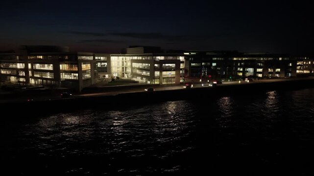 Admiral Park St Peter Port Guernsey.Drone footage from out at sea panning along Les Banques by night showing Vega Apartments,Martello Court and Dorey Court lit up with lights reflecting in calm sea