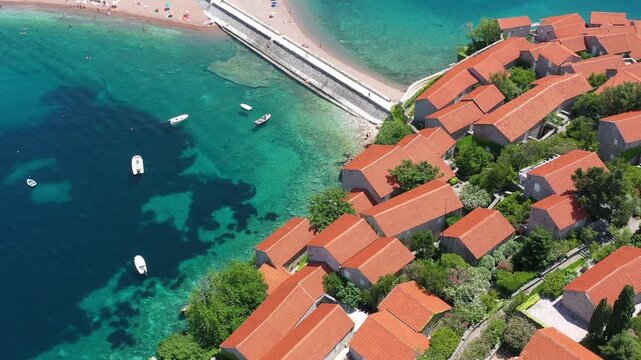 Aerial scenic view of Sveti Stefan island resort surrounded by turquoise Adriatic sea water in Montenegro.