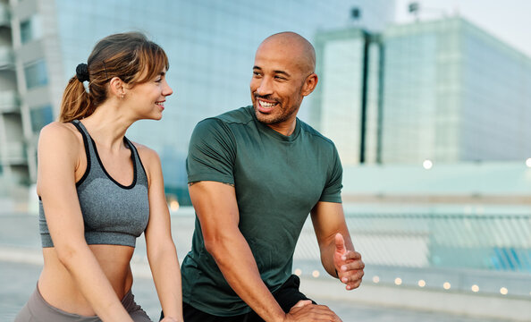 Portrait os a happy beautiful couple exercising and stretching outdoors