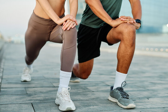 Portrait os a happy beautiful couple exercising and stretching outdoors
