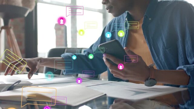 Man reacting to new messages, tapping phone, moving papers and managing business, chat icons rising