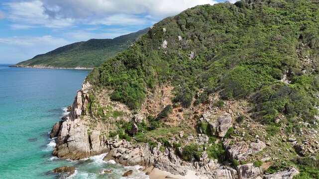 Cinematic Drone Flight Over Rocky Hill Revealing Ocean Waves at Ninh Van Bay, Khanh Hoa, Vietnam