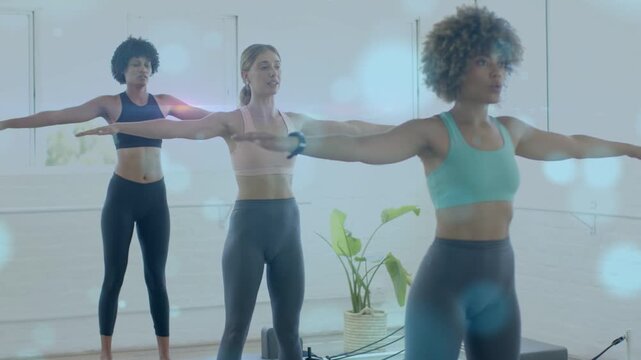 Three Pilates women standing on reformers, following center breath cue, syncing pulses for posture