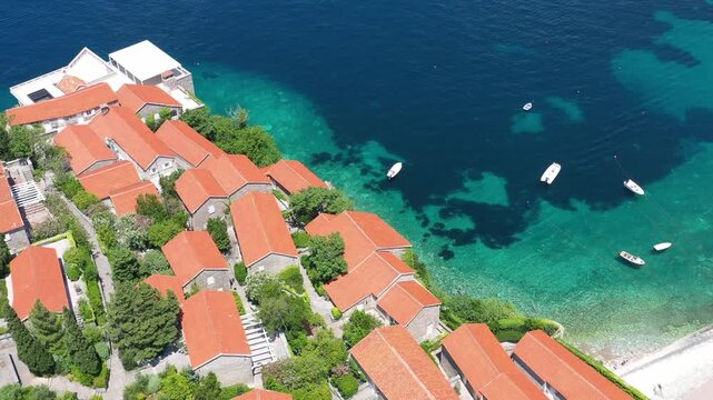 Aerial scenic view of Sveti Stefan island resort surrounded by turquoise Adriatic sea water in Montenegro.