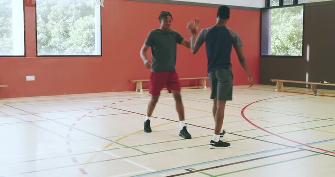 Asian coach blowing whistle while players receiving basketball dribbling contesting layup
