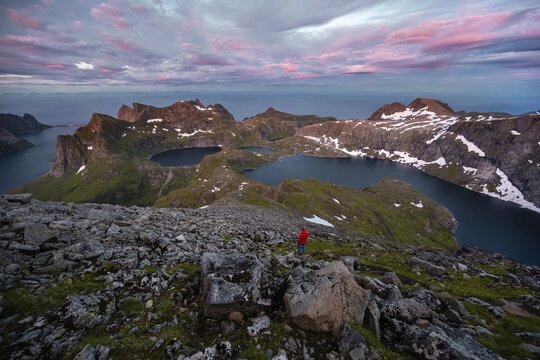 Sunset with dramatic clouds, hiker on hike to Hermannsdalstinden, lakes Krokvatnet and Tennesvatnet, mountains, Moskenes&oslash;ya, Lofoten, Nordland, Norway