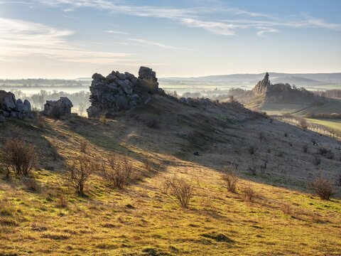 Rock formations in the Teufelsmauer nature reserve in morning light and morning fog, near Weddersleben, Harz, Saxony-Anhalt, Germany