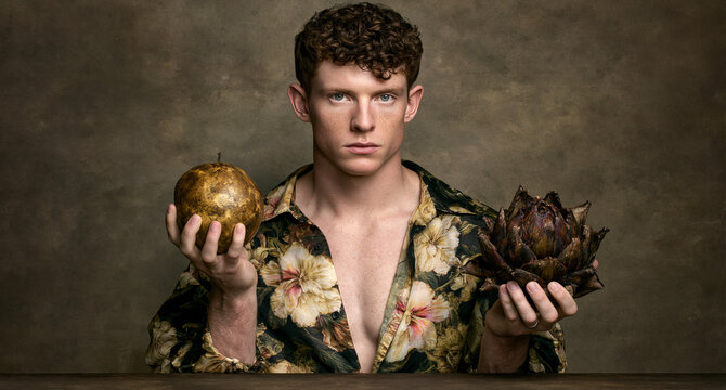 Man Holding Vegetables and Fruit in Dramatic Dark Portrait