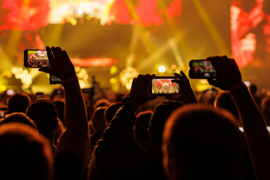 Crowds Holding Mobile Phones Up at Music Concert