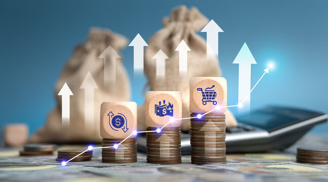 Wooden dice with financial icons on coin stacks and calculator, global inflation and rising cost of living concept.