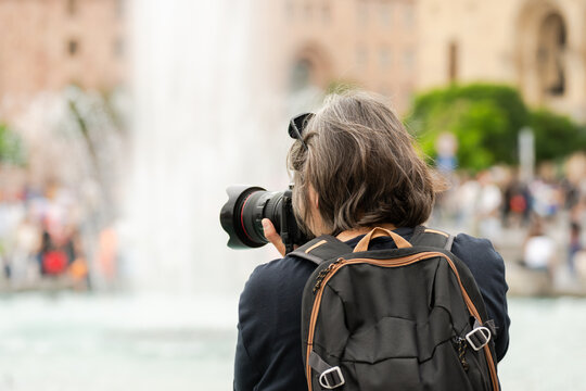 Photojournalist capturing real-life events with a professional camera, documenting news stories, public moments, and visual narratives for media and journalism purposes.