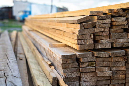 Wood processing workshop producing construction materials, featuring cutting, shaping, and preparing timber for building projects, representing industrial manufacturing and carpentry work.