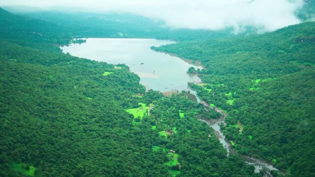 4K Landscape shot of lake in the Sahyadri hills as seen during the monsoon season from Savlya Ghat in Maharashtra, India. Scenic view of lake in the middle of the Western ghats in monsoon.