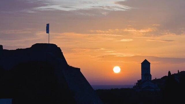 Scenic sunset over the silhouette of Ulcinj, Montenegro